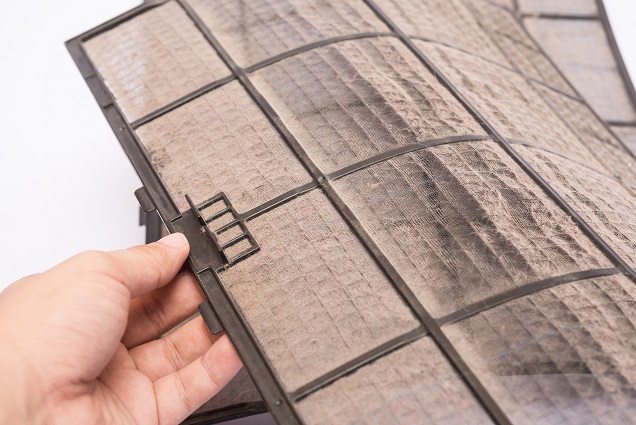 Person removing dirty air filter