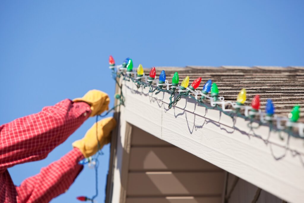 homeowner installing christmas lights